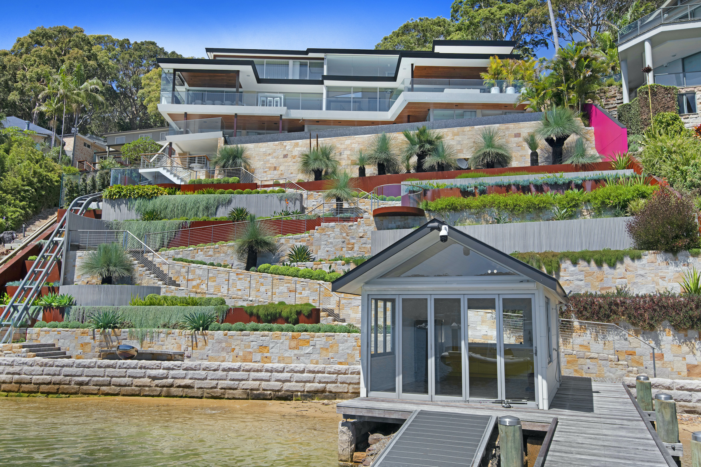 Retaining walls clad in sandstone and landscaping